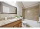 Full bathroom with a vanity, shower, and tub combination enclosed with neutral tile at 3078 W 107Th Pl # D, Westminster, CO 80031