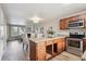 Bright kitchen featuring granite countertops, wood cabinets, and stainless steel appliances at 3078 W 107Th Pl # D, Westminster, CO 80031