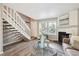 A staircase leads up in this living room featuring a fireplace and neutral decor at 3078 W 107Th Pl # D, Westminster, CO 80031