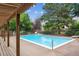 Community swimming pool surrounded by lush greenery and a wooden pergola at 3078 W 107Th Pl # D, Westminster, CO 80031