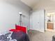 Tranquil bedroom featuring a cozy bed, stylish lamp, and convenient access to a bathroom at 8361 S Upham Way # 209, Littleton, CO 80128