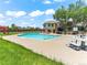 Inviting community pool surrounded by lounge chairs, picnic tables and an adjacent recreation center at 8361 S Upham Way # 209, Littleton, CO 80128