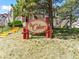 Exterior shot of the Colony community sign with surrounding buildings, grass, and yellow steps at 8361 S Upham Way # 209, Littleton, CO 80128