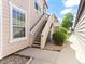 Charming exterior view showcases stairs leading to unit 209 with lovely landscaping at 8361 S Upham Way # 209, Littleton, CO 80128