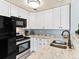 Updated kitchen showcasing sleek stainless steel appliances and granite countertops at 8361 S Upham Way # 209, Littleton, CO 80128
