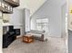 Cozy living room with a fireplace, large window, and neutral color palette at 8361 S Upham Way # 209, Littleton, CO 80128