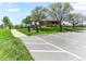 Exterior shot of the 'The Landing' recreation center with a parking lot, lawn and path at 8361 S Upham Way # 209, Littleton, CO 80128