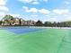Well-maintained tennis court in a community setting under a blue sky with scattered clouds at 8361 S Upham Way # 209, Littleton, CO 80128
