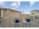 Cozy balcony features seating, a small table, and views of neighboring homes and landscaping at 8095 E 128Th Pl, Thornton, CO 80602