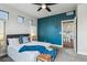 Well-lit bedroom with accent wall, ceiling fan, and easy access to kitchen at 8095 E 128Th Pl, Thornton, CO 80602
