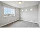 Bright bedroom with large window and neutral carpet and paint at 8095 E 128Th Pl, Thornton, CO 80602