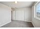 Spacious bedroom featuring neutral walls, plush carpeting, and a large closet with sliding doors at 8095 E 128Th Pl, Thornton, CO 80602