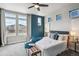 Bright bedroom with a large window, stylish furniture, and a decorative accent wall at 8095 E 128Th Pl, Thornton, CO 80602