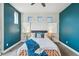 Comfortable bedroom with stylish décor, accent wall and modern lighting at 8095 E 128Th Pl, Thornton, CO 80602