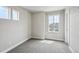 Well-lit bedroom with soft carpet, multiple windows, and neutral paint, creating a serene atmosphere at 8095 E 128Th Pl, Thornton, CO 80602