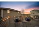 Outdoor deck featuring chairs and a table with string lights and sunset views at 8095 E 128Th Pl, Thornton, CO 80602