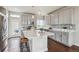 This open kitchen features gray cabinets, stainless appliances, a large island, and access to the backyard at 8095 E 128Th Pl, Thornton, CO 80602