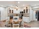 Finished basement kitchenette with white cabinets, granite counters, and small dining table at 8115 Monte Vista Cir, Littleton, CO 80125