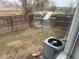 Backyard area of the house with green grass and a partially disassembled greenhouse kit at 2005 W 86Th Ave, Denver, CO 80260