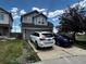 A two-story home with gray siding, a two car garage, and a concrete driveway on a sunny day at 2005 W 86Th Ave, Denver, CO 80260