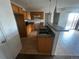A view of the kitchen and wet bar, featuring wooden cabinets, and tile flooring at 2005 W 86Th Ave, Denver, CO 80260
