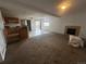 Open-concept living space with tile flooring, a fireplace, and neutral wall paint at 2005 W 86Th Ave, Denver, CO 80260