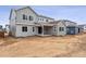 Backyard of a two-story home with gray siding, large windows, and a covered patio at 2560 Wesley Ln, Lafayette, CO 80026