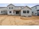 Spacious backyard of a gray two-story home, showcasing a covered patio and ample room for landscaping at 2560 Wesley Ln, Lafayette, CO 80026