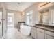 Luxurious bathroom featuring a modern soaking tub, dual sinks, and shower for a spa-like experience at 2560 Wesley Ln, Lafayette, CO 80026