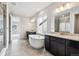 Luxurious bathroom showcasing a standalone tub, dual vanities, tile floors, and a glass shower at 2560 Wesley Ln, Lafayette, CO 80026