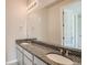 Elegant bathroom boasts a double sink vanity with granite countertop and decorative lighting at 2560 Wesley Ln, Lafayette, CO 80026