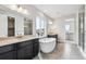 Modern bathroom with a standalone tub, granite countertops, tile floors, and updated fixtures at 2560 Wesley Ln, Lafayette, CO 80026