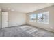 Bright bedroom with large windows, neutral carpet, and closet, perfect for relaxation and comfort at 2560 Wesley Ln, Lafayette, CO 80026