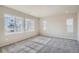 Bedroom featuring three windows bringing in lots of natural light, and neutral colored carpet at 2560 Wesley Ln, Lafayette, CO 80026