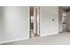 Bright bedroom featuring plush carpeting, an open bathroom doorway, and neutral wall paint at 2560 Wesley Ln, Lafayette, CO 80026