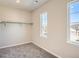 Cozy bedroom features neutral walls, plush carpet, and bright natural light from a window at 2560 Wesley Ln, Lafayette, CO 80026