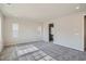 Spacious bedroom showcasing neutral carpet, two windows, and an open doorway enhancing the room's appeal at 2560 Wesley Ln, Lafayette, CO 80026