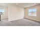 Spacious bonus room with soft carpet, recessed lighting, and natural light from two windows at 2560 Wesley Ln, Lafayette, CO 80026