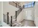 Elegant entryway featuring a staircase with black railings and hardwood floors, and double doors at 2560 Wesley Ln, Lafayette, CO 80026