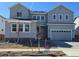 Beautiful two-story home with a gray facade and well-manicured lawn at 2560 Wesley Ln, Lafayette, CO 80026