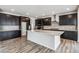 A modern kitchen boasting dark cabinetry, a white island, and stainless steel appliances at 2560 Wesley Ln, Lafayette, CO 80026