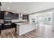 Open-concept kitchen with dark cabinetry, a large island, and stainless steel appliances at 2560 Wesley Ln, Lafayette, CO 80026