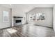 Bright living room with a fireplace, multiple windows, and wood-look flooring at 2560 Wesley Ln, Lafayette, CO 80026