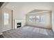 Bright living room with large windows, fireplace, and carpeted floors, showcasing a cozy ambiance at 2560 Wesley Ln, Lafayette, CO 80026