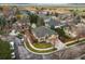 High angle aerial view of a lovely home featuring a 3-car garage, stone accents, and manicured landscape at 5497 W Prentice Ct, Littleton, CO 80123
