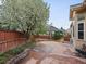 Backyard with stamped concrete, a well manicured lawn and mature shade trees at 5497 W Prentice Ct, Littleton, CO 80123