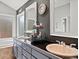 Bathroom with natural light, double vanity, and large soaking tub at 5497 W Prentice Ct, Littleton, CO 80123