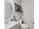 Half bath with a modern sink, large mirror, and decor at 5497 W Prentice Ct, Littleton, CO 80123