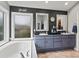 Bathroom with large soaker tub, dark walls, and double vanity with lots of counter space at 5497 W Prentice Ct, Littleton, CO 80123