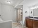 Bathroom featuring a glass-enclosed shower, stylish vanity, and tiled flooring at 5497 W Prentice Ct, Littleton, CO 80123